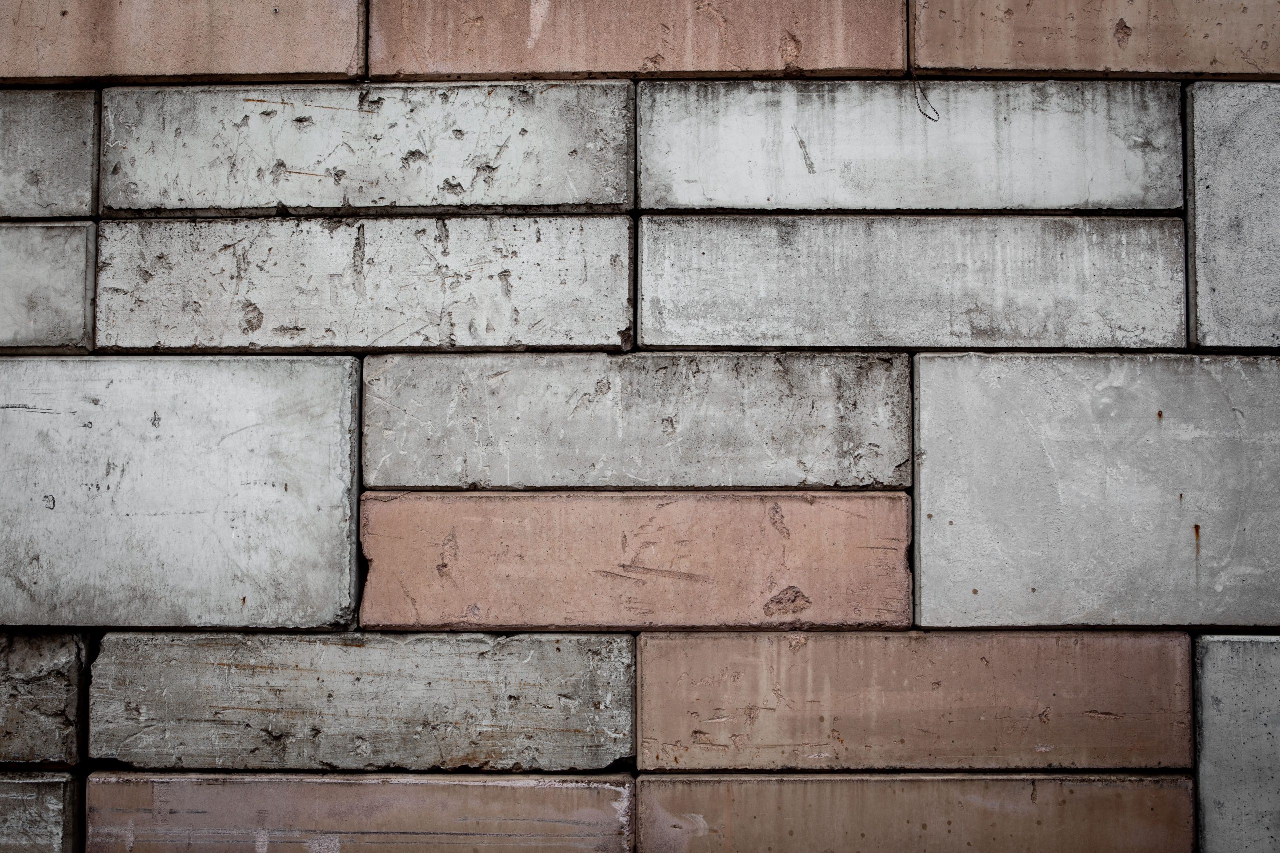 Close-up view of a textured brick and concrete wall, ideal for design and architecture projects.